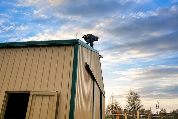 Lightning Rod Installer on Barn Roof Lightning Rod Installer on Barn Roof